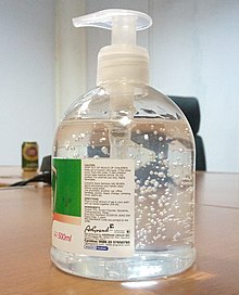 Disinfectant bottle and hands